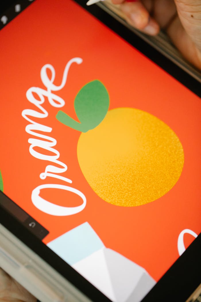 A vibrant digital illustration of an orange on a tablet screen, featuring bold and bright colors.